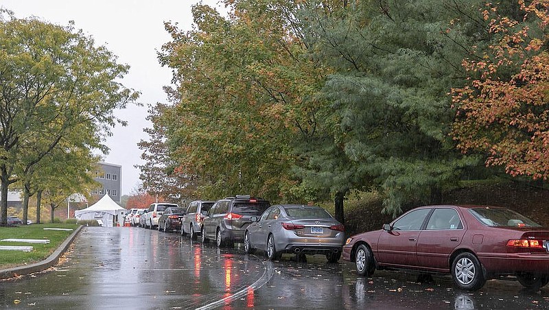 Motorists line up for drive-thru coronavirus testing Friday at MidState Medical Center in Meriden, Conn. Hartford HealthCare, the parent company of MidState, has had a sudden spike in testing demand at all its centers, according to a Hartford HealthCare spokeswoman.
(AP/Record-Journal/Dave Zajac)