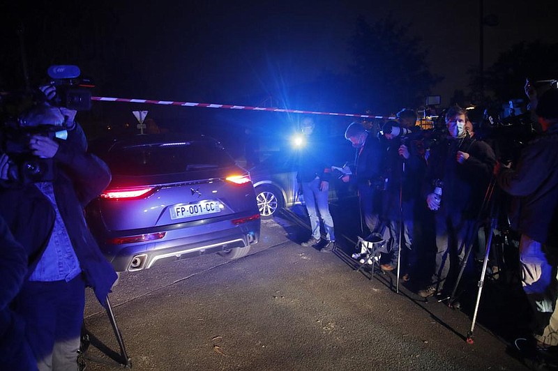 A police car arrives in the area in the town of Conflans-Saint-Honorine in France where a teacher was decapitated by a man apparently upset over a class discussion regarding the Prophet Muhammad.
(AP/Michel Euler)