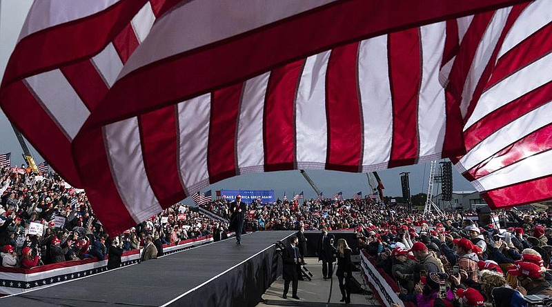 President Donald Trump makes his exit after speaking at a campaign rally Saturday at the Muskegon County Airport in Norton Shores, Mich. More photos at arkansasonline.com/1018campaign/.
(AP/Alex Brandon)