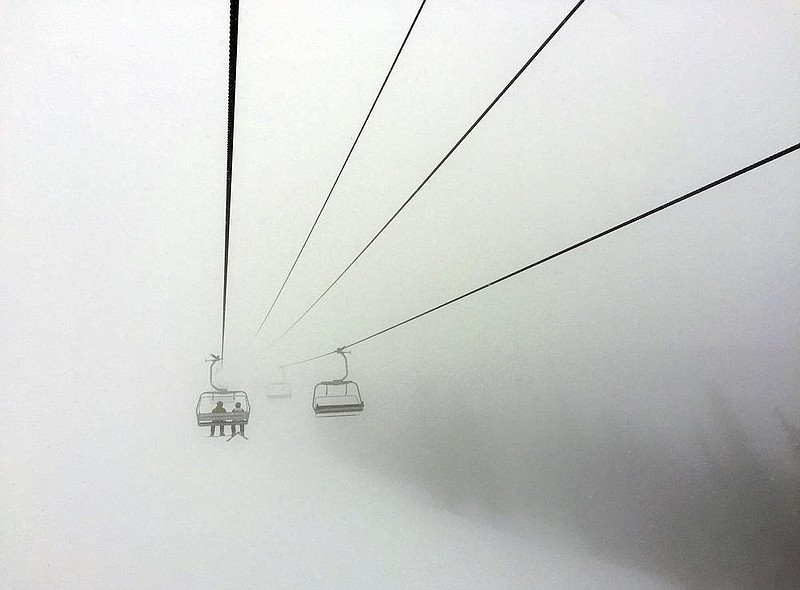 Skiers ride a chair lift into a bank of fog at Colorado’s Beaver Creek Resort in March 2019. Resorts are trying to get back in operation this winter under a changed environment.
(AP/Thomas Peipert)