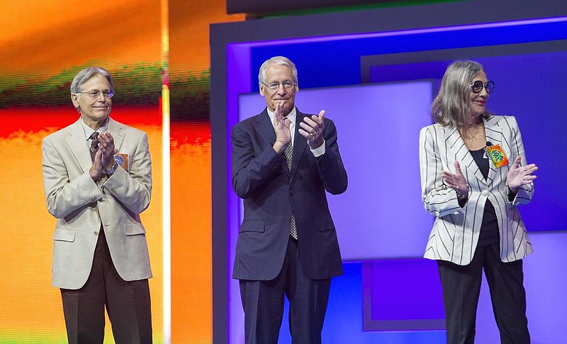 Jim Walton (from left), Rob Walton and Alice Walton stand on stage for the presentation of the Sam Walton Award during the annual Walmart shareholders meeting at Bud Walton Arena in Fayetteville in June 2015.
(NWA Democrat-Gazette/JASON IVESTER)