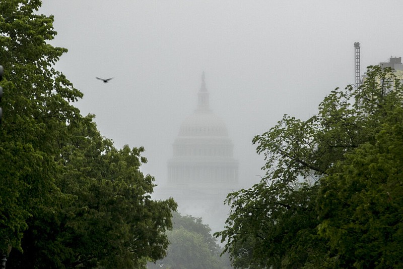 FILE - In this May 22, 2020, file photo the Dome of the U.S. Capitol Building is visible through heavy fog in Washington. New virus relief will have to wait until after the November election. Congress is past the point at which it can deliver more coronavirus aid soon, with differences between House Speaker Nancy Pelosi, Senate Republicans and President Donald Trump proving insurmountable. (AP Photo/Andrew Harnik, File)

