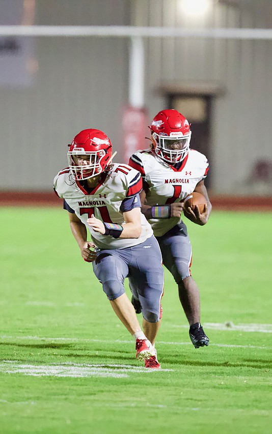 Magnolia running back Garrion Curry (1) follows blocker Peyton Creech (71). The sophomore had 141 receiving yards, 137 rushing yards and accounted for three touchdowns during a 52-33 win over Hot Springs Friday night.