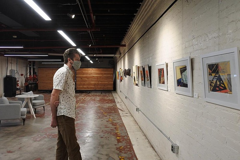 Jarrod Cluck takes in works from the exposition Her Voice during the opening reception of the District Galleries in the Bakery District in downtown Fort Smith on Friday, Oct. 9, 2020. 
(Arkansas Democrat-Gazette/Thomas Saccente)