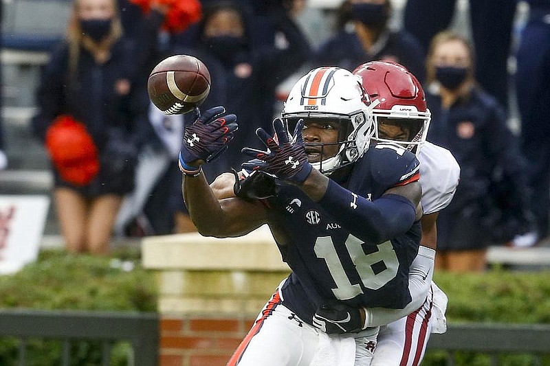 n Auburn wide receiver Seth Williams (18) tries to catch a pass as Arkansas defensive back Khari Johnson (19) defends. The Razorbacks have an open date this week before resuming play at No. 7 Texas A&M on Oct. 31.