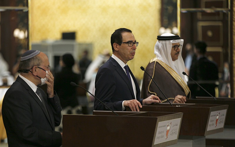 U.S. Treasury Secretary Stephen Mnuchin speaks after an Israeli delegation signed an agreement with Bahraini officials in Manama, Bahrain, Sunday, Oct. 18, 2020. President Donald Trump on Monday, Oct. 19, 2020 said Sudan will be removed from the U.S. list of state sponsors of terrorism if it follows through on its pledge to pay $335 million to American terror victims and families. The decision, announced after Mnuchin was in Bahrain to cement the Gulf state’s recognition of Israel, came as the Trump administration pursues further Arab recognition of Israel.