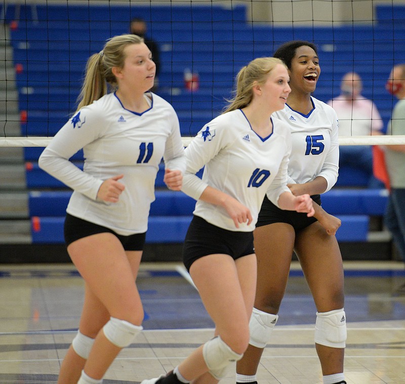 FILE -- Rogers' Phoenix Bailey (15), Lakyn Hawthorne (10) and Gracie Carr (11) celebrate a point Tuesday, Oct. 13, 2020, during play against Bentonville in King Arena in Rogers. (NWA Democrat-Gazette/Andy Shupe)