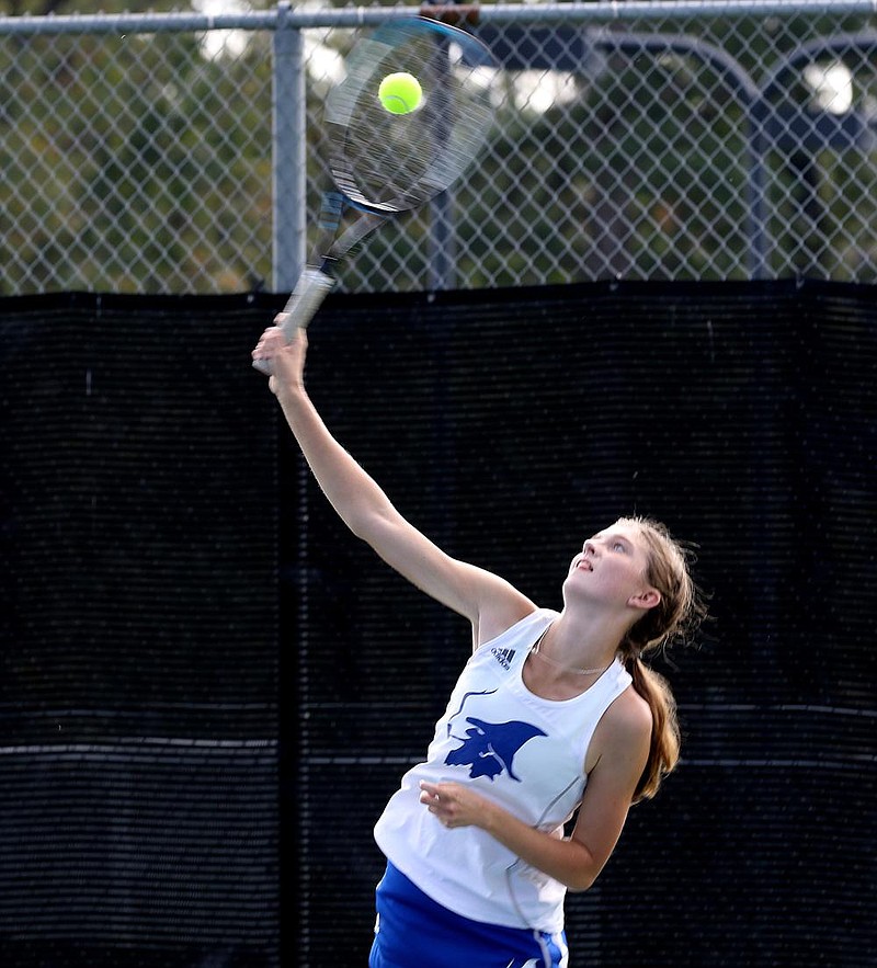 Jenna Kate Bohnert of Rogers serves during the girls doubles final match with partner Grace Lueders (front) during the girls state Overall tennis tournament. Bohnert and Lueders defeated Leena Cashman and Naya Kessman of Haas Hall Fayetteville 3-6, 6-3, 6-4 
(Arkansas Democrat-Gazette/Thomas Metthe) 