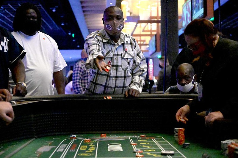 Marlin Guy throws dice at the craps table after a grand opening and ribbon cutting ceremony at the Saracen Casino in Pine Bluff on Tuesday, Oct. 20, 2020. The Casinos 80,000 square-foot casino gaming floor contains 2,000 slot machines, 35 table games, Sportsbook, a Poker Room and multiple food and beverage options, according to a press release.

(Arkansas Democrat-Gazette/Stephen Swofford)