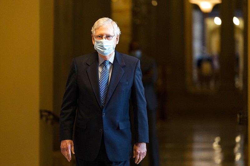 FILE - In this Oct. 1, 2020, file photo Senate Majority Leader Sen. Mitch McConnell of Ky. walks towards the Senate floor on Capitol Hill in Washington.