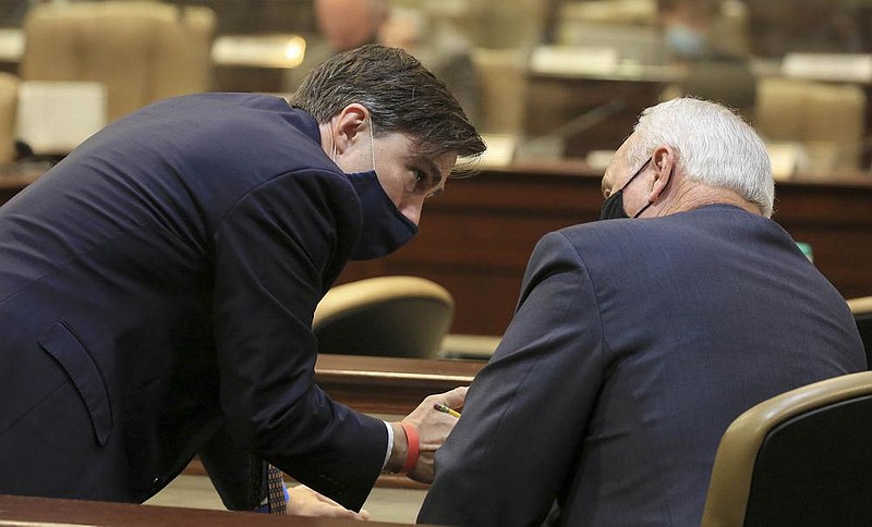 Larry Walther, right, Secretary of the Department of Finance and Administration and Jake Bleed, state budget director, talk Tuesday Oct. 13, 2020 during the first day of budget hearings at the state Capitol. (Arkansas Democrat-Gazette/Staton Breidenthal)