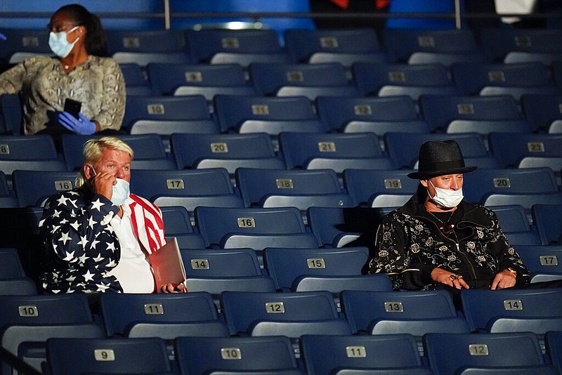 Golfer John Daly (left), formerly of Dardanelle and the Arkansas Razorbacks, and performer Kid Rock take their seats before the start of the second and final presidential debate Thursday, Oct. 22, 2020, at Belmont University in Nashville.