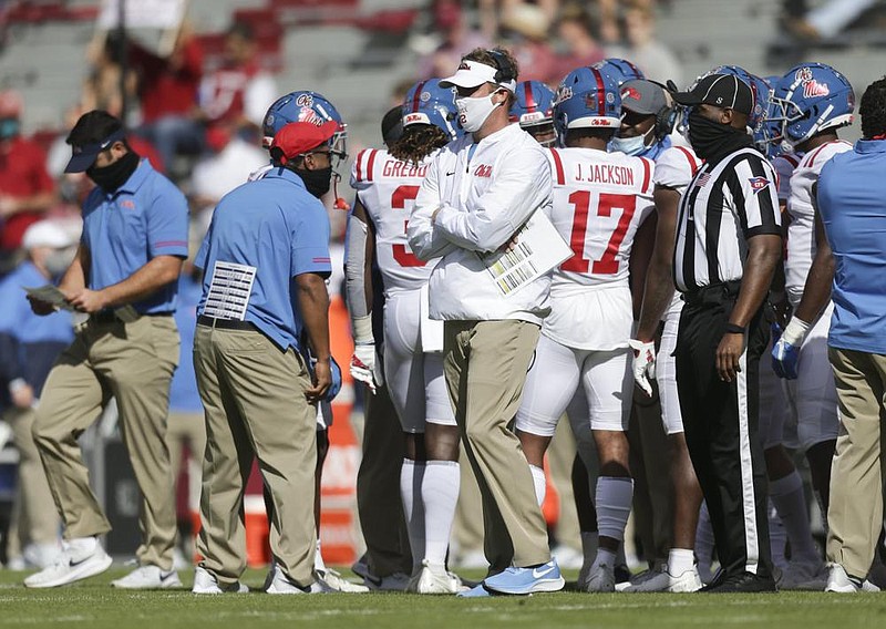 Ole Miss Coach Lane Kiffin instructs a receiver during the Rebels’ loss at Arkansas on Saturday. Kiffin took ribbing he received from the Razorbacks’ Twitter account in stride after Arkansas’ victory over his team. 
(NWA Democrat-Gazette/Charlie Kaijo) 