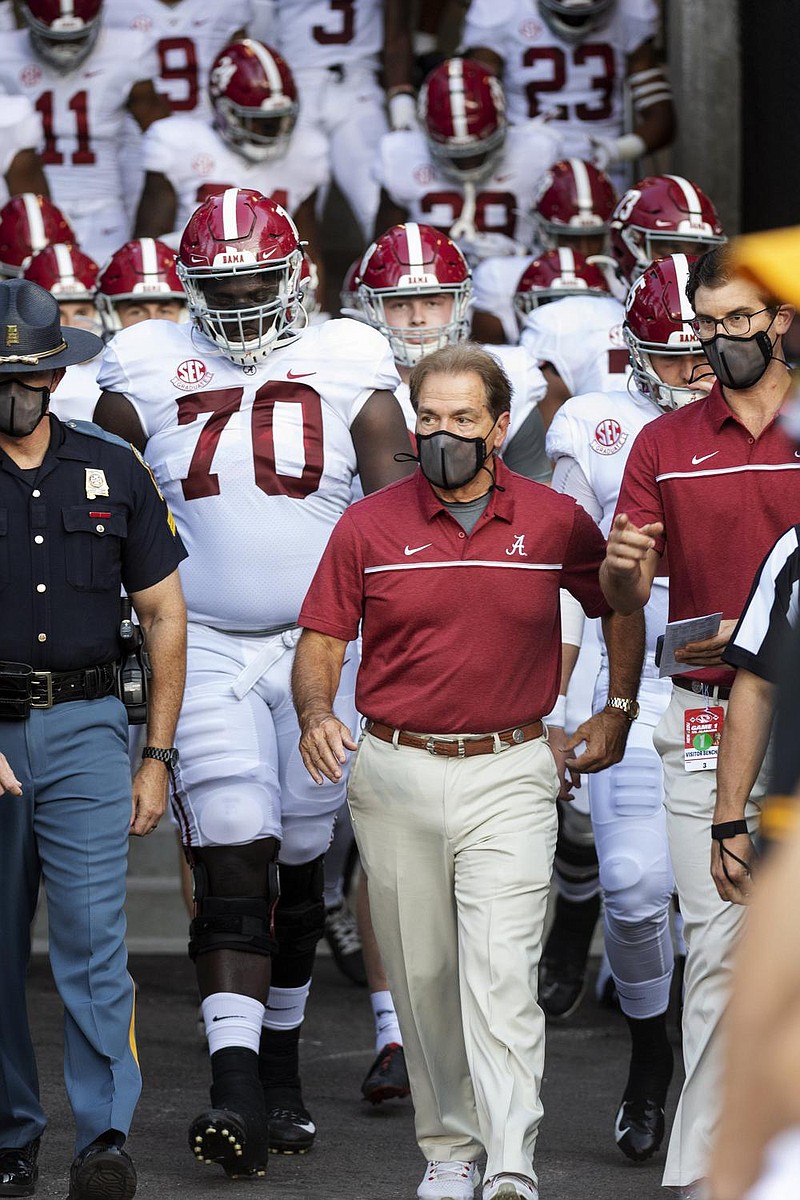 Alabama Coach Nick saban (front) led his team to victory over Georgia last week, hours after a third negative covid-19 test. The dean of the brown university school of Public health, dr. ashish Jha called it “a reminder of the stark disparity between the haves and have-nots.” 
(aP/L.G. Patterson) 