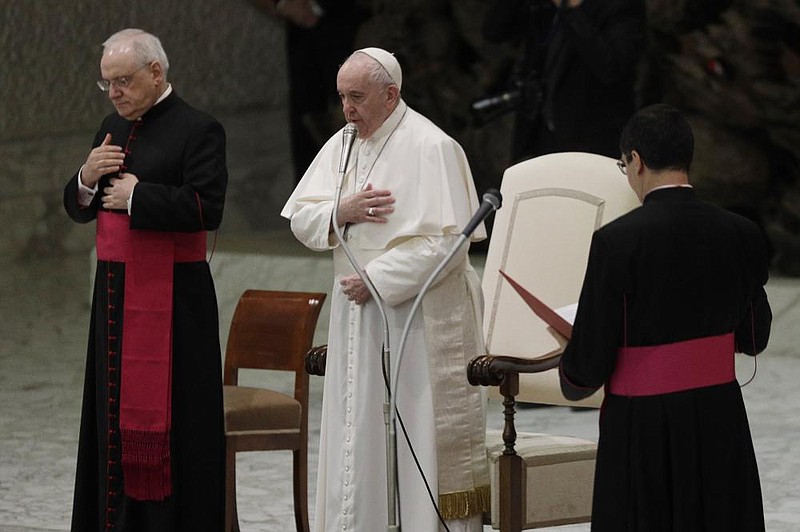 Pope Francis makes the sign of the cross Wednesday during his weekly general audience in the Paul VI Audience Hall at the Vatican. (AP/Gregorio Borgia) 