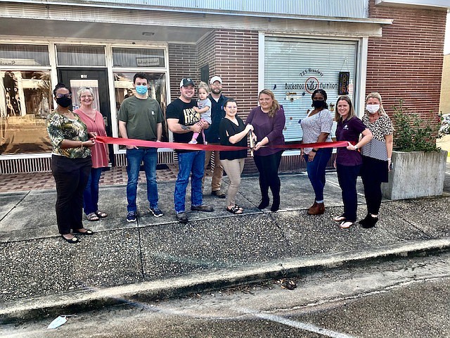 Pictured from left to right are Regina Powell, Rhanda Wright, Sawyer Stanton, Jason Waxley, co-owner Danielle Monroe, co-owner Heather Schofer, Katrina Embry, Stephanie Thomas and Stacy Mullin. (Contributed) story.lead_photo.caption