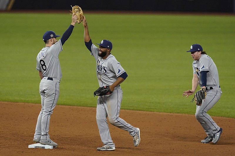The Tampa Bay Rays celebrates their win against the Los Angeles Dodgers in Game 2 of the baseball World Series Wednesday, Oct. 21, 2020, in Arlington, Texas. Ray beat the Dodgers 6-4.