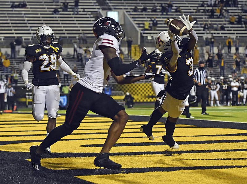 Appalachian State defensive back Shaun Jolly (right) breaks up a pass in the end zone intended for Arkansas State University receiver Jonathan Adams Jr. during the Mountaineers’ 45-17 victory over the Red Wolves on Thursday in Boone, N.C.
(AP/Winston-Salem Journal/Walt Unks)