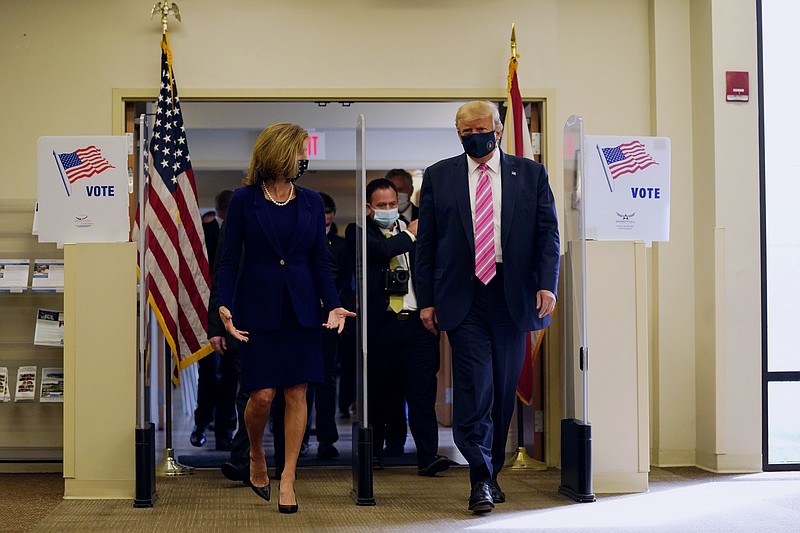 President Donald Trump walks with Wendy Sartory Link, Supervisor of Elections Palm Beach County, after casting his ballot for the presidential election, Saturday, Oct. 24, 2020, in West Palm Beach, Fla. (AP Photo/Evan Vucci)