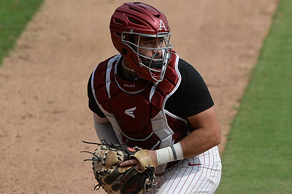 Arkansas catcher Casey Opitz fields a throw from the outfield Friday, Sept. 18, 2020, during practice at Baum-Walker Stadium in Fayetteville.