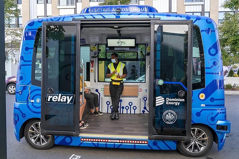 Jason Peres explains to new riders how Relay, an electric autonomous vehicle, works earlier this week in Fairfax, Va.
(AP/Jacquelyn Martin)