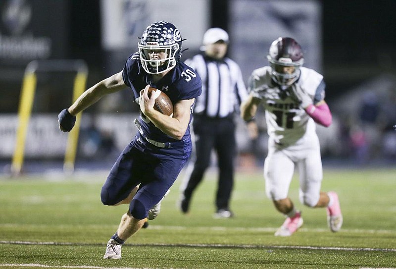 Greenwood running back Hunter Wilkinson (left) runs away from the Benton defense Friday during the Bulldogs’ 42-28 victory over the Panthers in Greenwood. See more photos at arkansasonline.com/1024benton/.
(NWA Democrat-Gazette/Charlie Kaijo)
