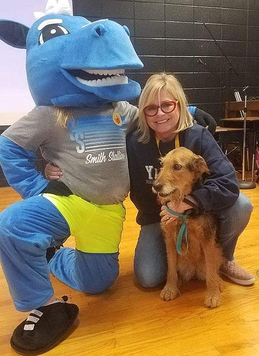 Former Springdale Elementary teacher Kathy Short poses March 13 with the school’s mascot and her dog. Short decided to retire this summer after 37 years in education because she didn’t feel comfortable going back to school during a pandemic. “It’s not my age. I’m healthy. I just didn’t feel safe,” she said. “I didn’t want to retire like this.” (Special to the Democrat-Gazette)