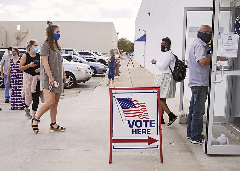 Voters wait in line Thursday to cast ballots at the Benton County Annex in Rogers. (NWA Democrat-Gazette/Charlie Kaijo)