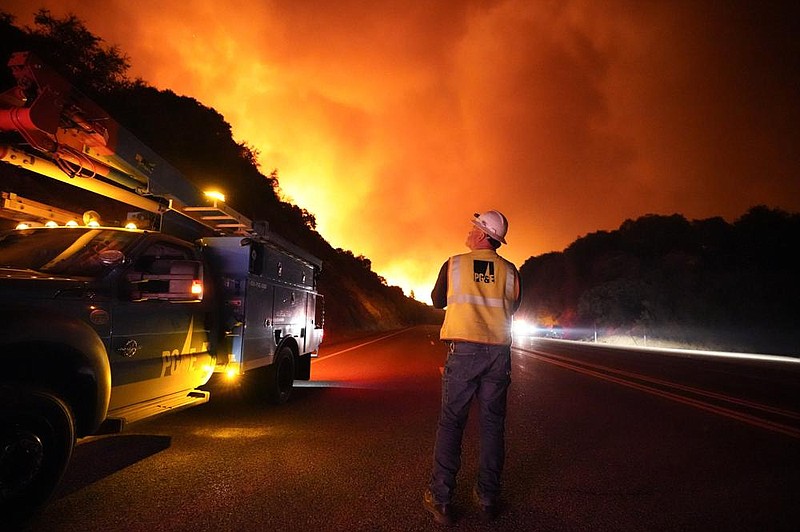 A Pacific Gas and Electric worker looks up at the advancing Creek Fire on Sept. 8 near Alder Springs, Calif.
(AP/Marcio Jose Sanchez)