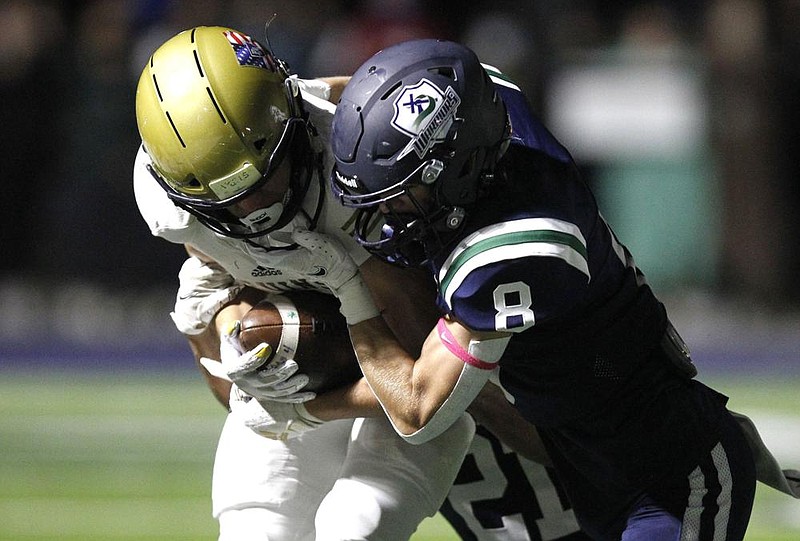 Pulaski Academy wide receiver Cooper White (left) tries to shake off Little Rock Christian defensive back Luke Lee on Friday during the fourth quarter of the Bruins’ 60-28 victory over the Warriors.
(Arkansas Democrat-Gazette/Thomas Metthe)