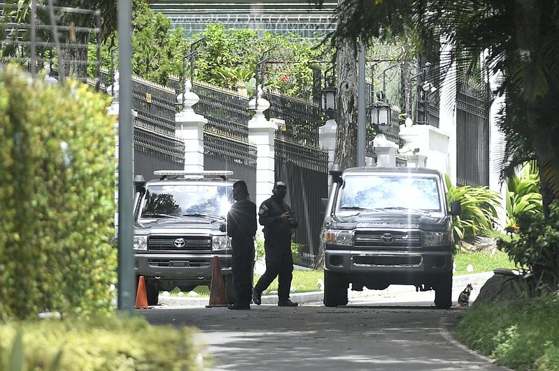 Members of the SEBIN intelligence police guard the perimeter Saturday of the Spanish ambassador’s residence in Caracas, Venezuela, where opposition leader Leopoldo Lopez had been a guest after participating in a failed military uprising.
(AP/Matias Delacroix) story.lead_photo.caption