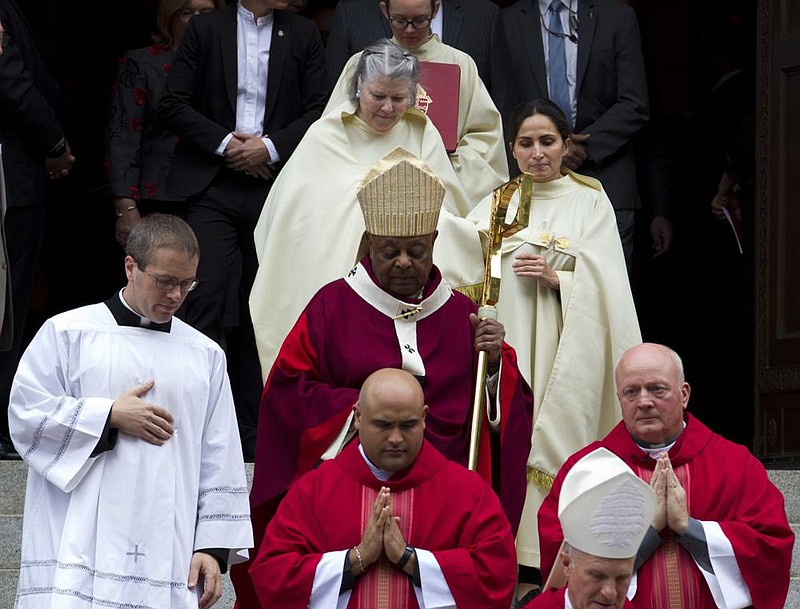 Washington, D.C., Archbishop Wilton Gregory, accompanied by other clergy members, leaves St. Matthews Cathedral on Oct. 6, 2019, after the annual Red Mass in Washington. (AP/Jose Luis Magana) 