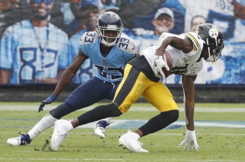 Pittsburgh Steelers wide receiver Diontae Johnson (right) gets past Tennessee Titans cornerback Johnathan Joseph en route to a touchdown in the first half Sunday in Nashville, Tenn. Johnson had two touchdowns to help the Steelers win 27-24 and improve to 6-0 for the first time since 1978. 
(AP/Wade Payne) 