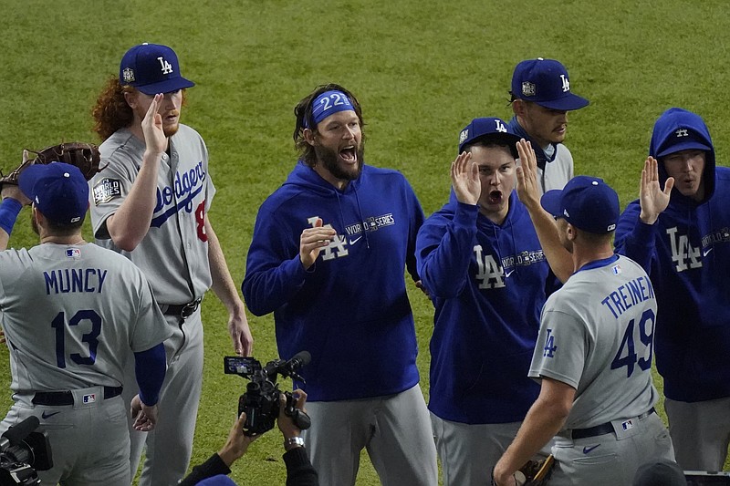 Los Angeles Dodgers starting pitcher Clayton Kershaw, center, celebrates after their win against the Tampa Bay Rays in Game 5 of the baseball World Series Sunday, Oct. 25, 2020, in Arlington, Texas. Dodgers beat the Rays 4-2 to lead the series 3-2 games. story.lead_photo.caption