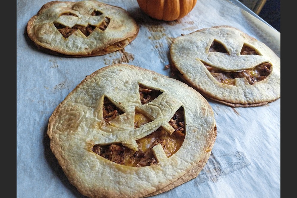 Stuffed with chicken and cheese, Jack-O’-Lantern Quesadillas make a quick and easy dinner on Halloween. (TNS/Pittsburgh Post-Gazette/Gretchen McKay)