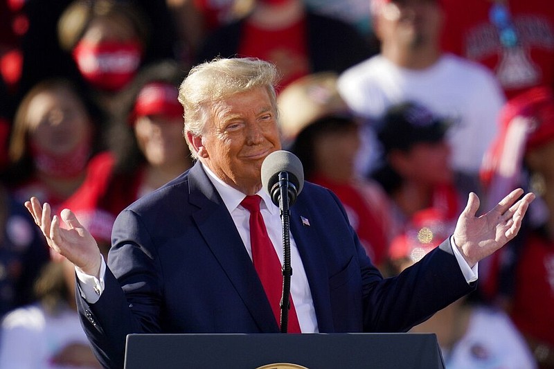 President Donald Trump gestures as he listens to a guest speaker on stage at a campaign rally at Phoenix Goodyear Airport in Goodyear, Ariz., on Wednesday, Oct. 28, 2020. (AP Photo/Ross D. Franklin)


