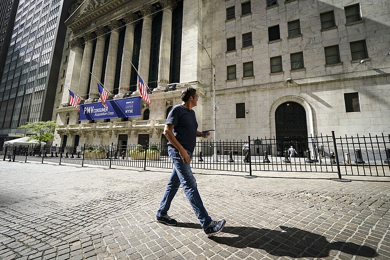 A pedestrian passes the New York Stock Exchange, Friday, Oct. 2, 2020, in New York.
