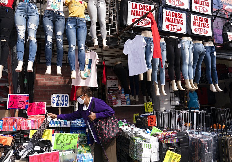 FILE - In this Sept. 25, 2020 file photo, a woman shops at a clothing store in New York.