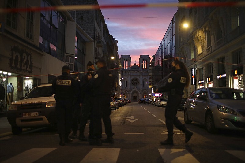 Police work behind a restricted zone near the Notre Dame church in Nice, southern France, after a knife attack took place on Thursday, Oct. 29, 2020.