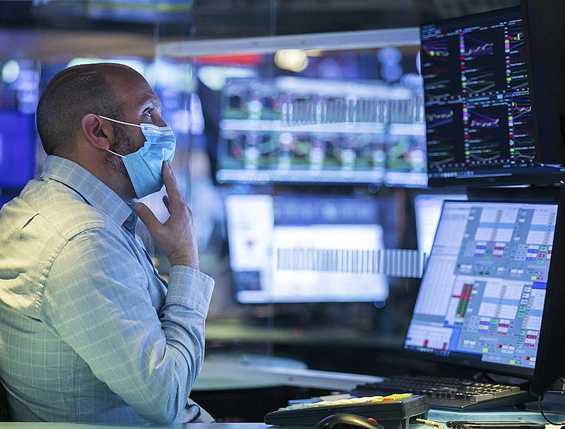 Specialist James Denaro works at his post Wednesday at the New York Stock Exchange as worries about coronavirus cases worldwide sent prices tumbling again.
(AP/New York Stock Exchange/Courtney Crow)