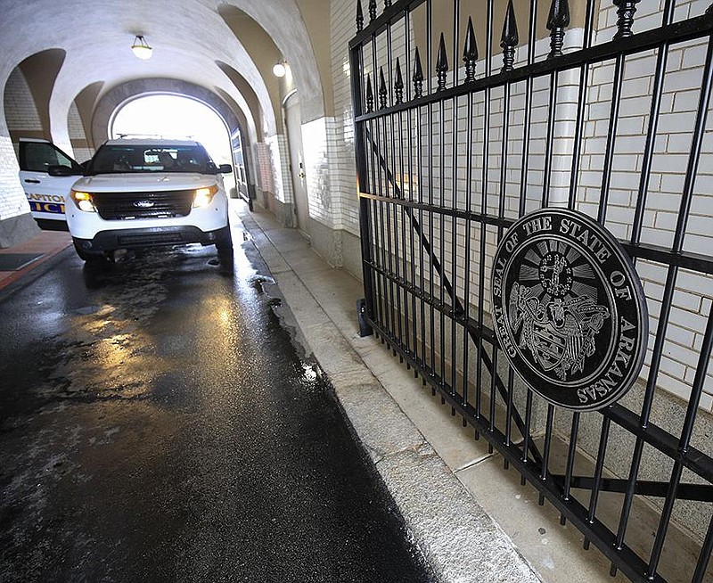 A Capitol Police vehicle stops in the tunnel Wednesday at the state Capitol in Little Rock near some newly installed security gates. The gates have been installed at each end of the tunnel.
(Arkansas Democrat-Gazette/Staton Breidenthal)