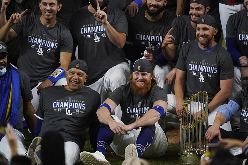 Los Angeles Dodgers manager Dave Roberts and third baseman Justin Turner pose for a group picture after the Dodgers defeated the Tampa Bay Rays 3-1 in Game 6 to win the baseball World Series, Tuesday, Oct. 27, 2020, in Arlington, Texas. (AP Photo/Eric Gay)