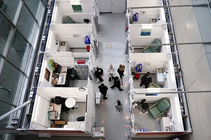 Medical personnel gather at an express coronavirus testing facility Wednesday at Boston Logan International Airport. The testing site is open for airport and airline employees, and will open to passengers and the general public in mid-November. More photos at arkansasonline.com/1029covid/.
(AP/Elise Amendola)