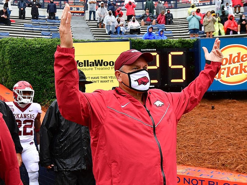 Arkansas coach Sam Pittman raises his arms during a game against Auburn. After an open week, the Hogs will be back in action Saturday at Texas A&M.