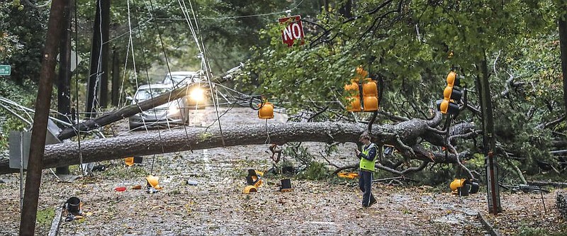 A tree blocks a street Thursday in Atlanta after bands of rain and damaging winds from Zeta swept through north Georgia. Downed trees also blocked lanes on two interstates in Atlanta, officials said.
(AP/Atlanta Journal-Constitution/John Spink)