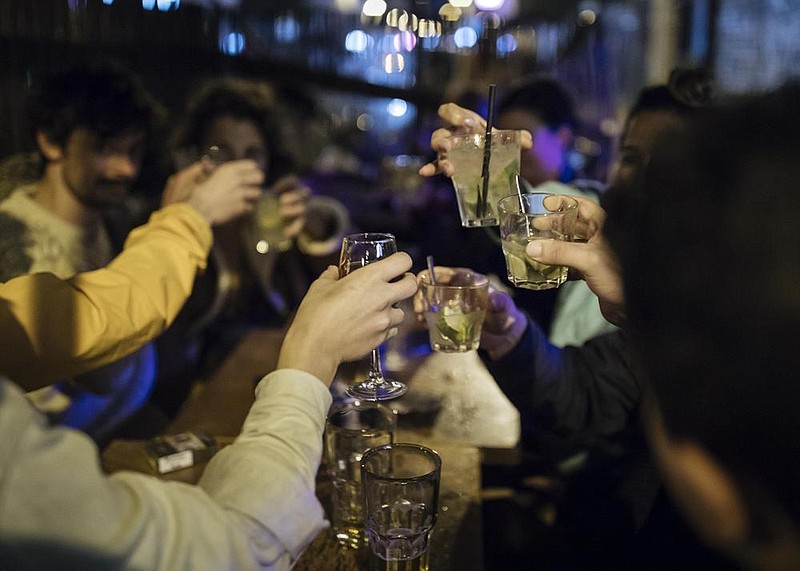 People share a toast Thursday on their last gathering for now on a bar terrace in Paris as France prepared for a new monthlong lockdown, and other European countries considered new measures as coronavirus cases soar. More photos at arkansasonline.com/1030covid/.
(AP/Lewis Joly)