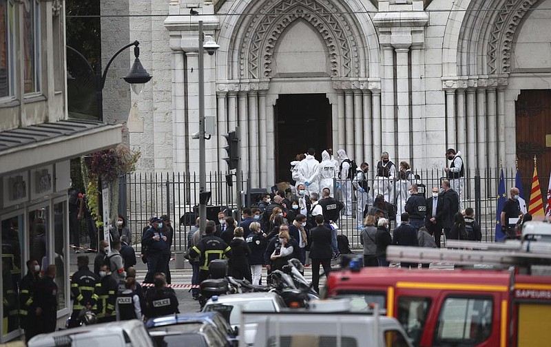 Police officers work at the scene of a knife attack Thursday at Notre Dame church in Nice, southern France. More photos at arkansasonline.com/1030france/.
(AP/Daniel Cole)