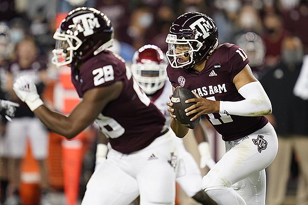 Texas A&M quarterback Kellen Mond (11) rushes against Arkansas during the first quarter of an NCAA college football game Saturday, Oct. 31, 2020, in College Station, Texas. (AP Photo/Sam Craft)


