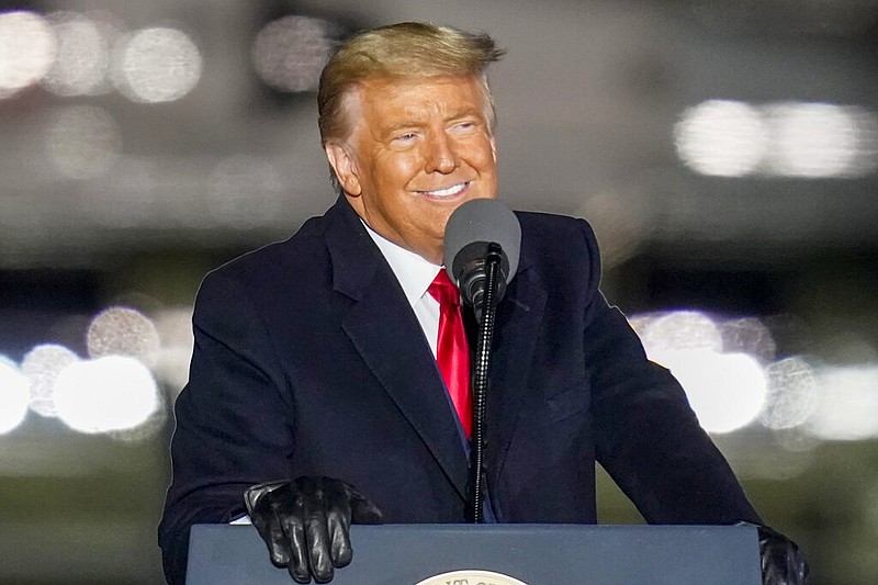 President Donald Trump smiles as he addresses the crowd during a campaign stop at the Butler County Regional Airport in Butler, Pa., on Saturday, Oct. 31, 2020.