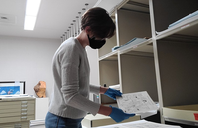Chaney Jewell, curator with the Arts and Science for Southeast Arkansas, prepares the pieces for the “Ballots & Laughs: Political Cartoons of Ray Walters” exhibit on view through Saturday, Jan. 9, 2021.
(Special to the Pine Bluff Commercial)